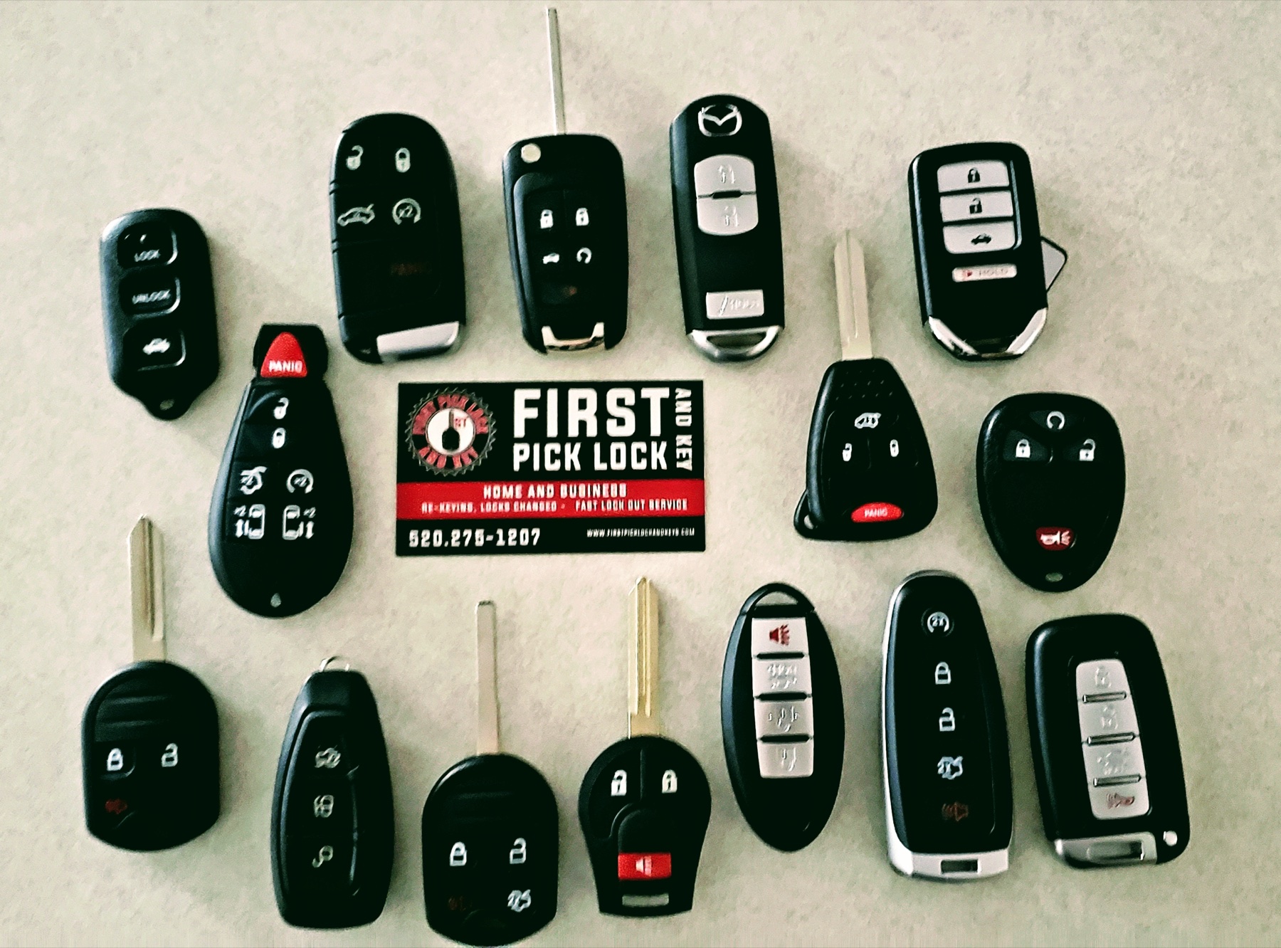 Automotive key programming tablet surrounded by key fobs